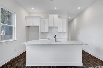 San Antonio house for rent - A kitchen with white cabinets and a marble countertop.