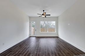 San Antonio house for rent - A room with a ceiling fan and wood flooring.