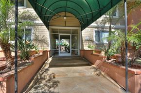Los Altos apartment for rent - A covered walkway with a green canopy and a stone floor.