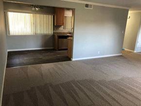 Los Altos apartment for rent - A room with a carpeted floor and a kitchenette in the corner.