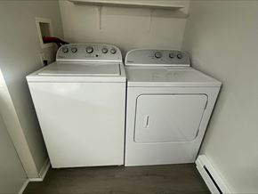 Lima apartment for rent - A white washing machine and dryer in a small laundry room.