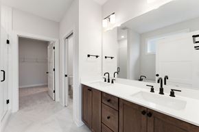 Maple Grove house for rent - A bathroom with a white countertop and brown cabinets.
