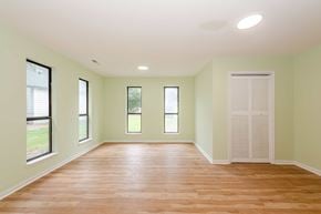 Jacksonville house for rent - A room with wooden floors and white walls.