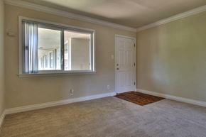 Mountain View apartment for rent - an empty living room with a window and a door
