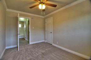 Mountain View apartment for rent - a bedroom with a ceiling fan and a door to a hallway