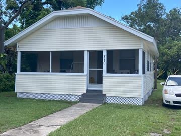 Clearwater house for rent - A small white house with a car parked in front.