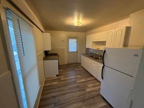 Fremont apartment for rent - A kitchen with white appliances and wooden floors.