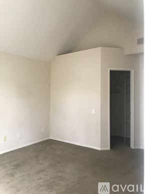 San Diego apartment for rent - A spacious room with a carpeted floor and white walls.