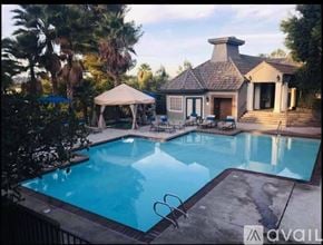 San Diego apartment for rent - A pool with a house and a canopy in the background.