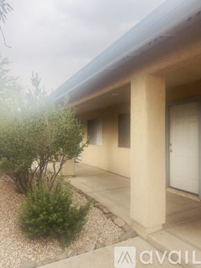 Tucson townhouse for rent - A room with a door, window, and carpeted floor.