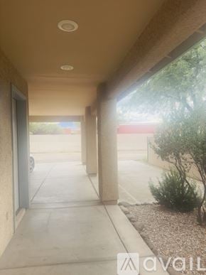 Tucson townhouse for rent - A room with a carpeted floor and a wall socket.