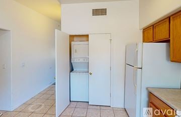 Tucson townhouse for rent - A kitchen with a white refrigerator and a white washing machine.