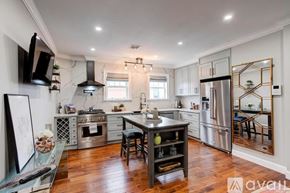 Boston apartment for rent - A kitchen with a wooden table and stainless steel appliances.