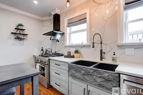Boston apartment for rent - A kitchen with a marble countertop and a sink.
