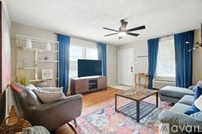 Lubbock townhouse for rent - A bedroom with a large bed and a painting on the wall.