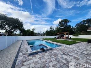 Palm Coast house for rent - A backyard with a pool and patio area.