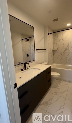 Tampa apartment for rent - A bedroom with a bed, a ceiling fan, and a closet.