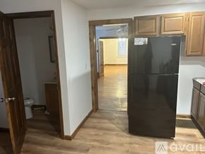 Bellefonte apartment for rent - A black fridge in a room with wooden floors and white walls.
