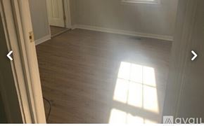 Knoxville house for rent - A room with wooden flooring and a window letting in sunlight.