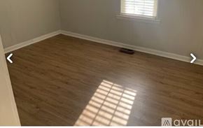 Knoxville house for rent - A room with wooden flooring and a window letting in sunlight.
