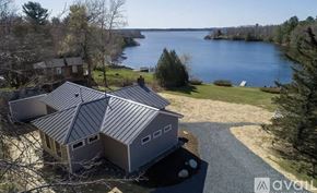 Ellsworth house for rent - A house with a grey roof is surrounded by nature.