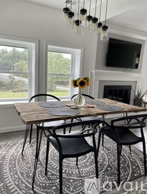 Ellsworth house for rent - A dining room with a wooden table and chairs.