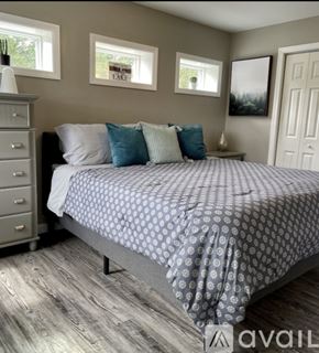 Ellsworth house for rent - A bedroom with a bed, nightstand, and a dresser.
