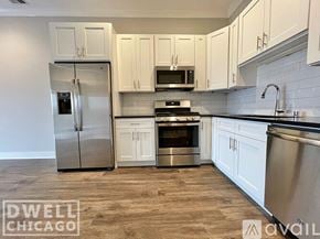Chicago apartment for rent - A kitchen with white cabinets and a stainless steel refrigerator.