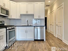 Chicago apartment for rent - A kitchen with white cabinets and a stainless steel dishwasher.