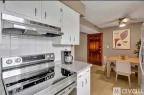 Newburgh apartment for rent - A modern kitchen with white cabinets and a stainless steel oven.