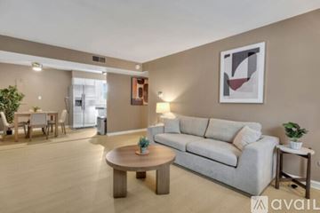 Newburgh apartment for rent - A living room with a couch, coffee table, and a painting on the wall.