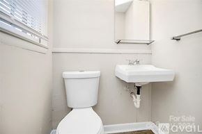 Charlotte house for rent - A white toilet and sink in a small bathroom.