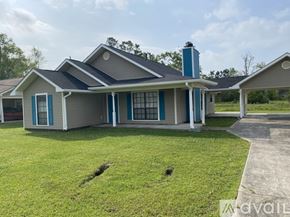 Ponchatoula house for rent - A house with a blue roof and a chimney.