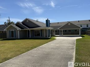 Ponchatoula house for rent - A living room with a fireplace and wood flooring.
