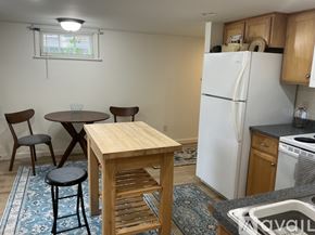 Ellsworth apartment for rent - A kitchen with wooden cabinets and a white door.