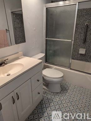 Hallandale Beach apartment for rent - A white toilet sits in a bathroom with a tiled floor.
