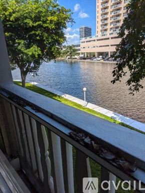 Hallandale Beach apartment for rent - A view from a balcony overlooking a river and a cityscape.