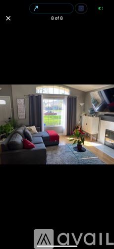Menifee apartment for rent - A living room with a grey couch and a red pillow.