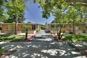 Palo Alto apartment for rent - A row of buildings with trees in front.