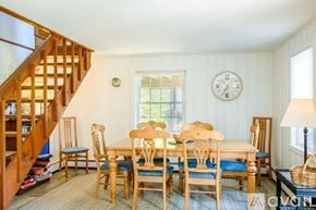 Sandwich house for rent - A dining room with a wooden table and chairs.