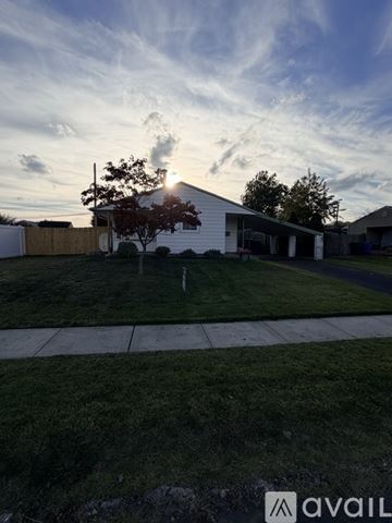 Levittown house for rent - A kitchen with wooden cabinets and a ceiling fan.