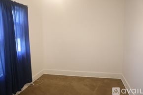 Hutchinson apartment for rent - A room with a blue curtain on the left and a carpet on the floor.