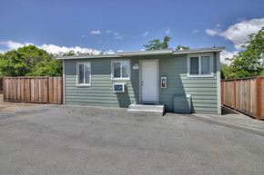 Sunnyvale apartment for rent - A small green house with a white door and windows.