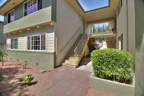 Sunnyvale apartment for rent - A building with a green bush in front of it.