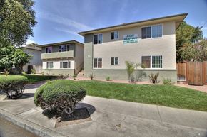 Sunnyvale apartment for rent - A building with a green lawn and a sign that says