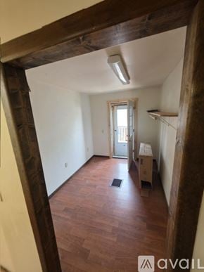 Clare house for rent - A room with wooden floors and a door on the left.