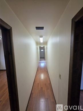 Clare house for rent - A room with wooden floors and a window.