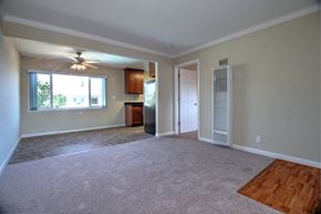 Menlo Park apartment for rent - an empty living room with a ceiling fan and a window