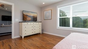 Fairview house for rent - A bedroom with a dresser and a painting on the wall.