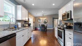 Fairview house for rent - A kitchen with white cabinets and stainless steel appliances.